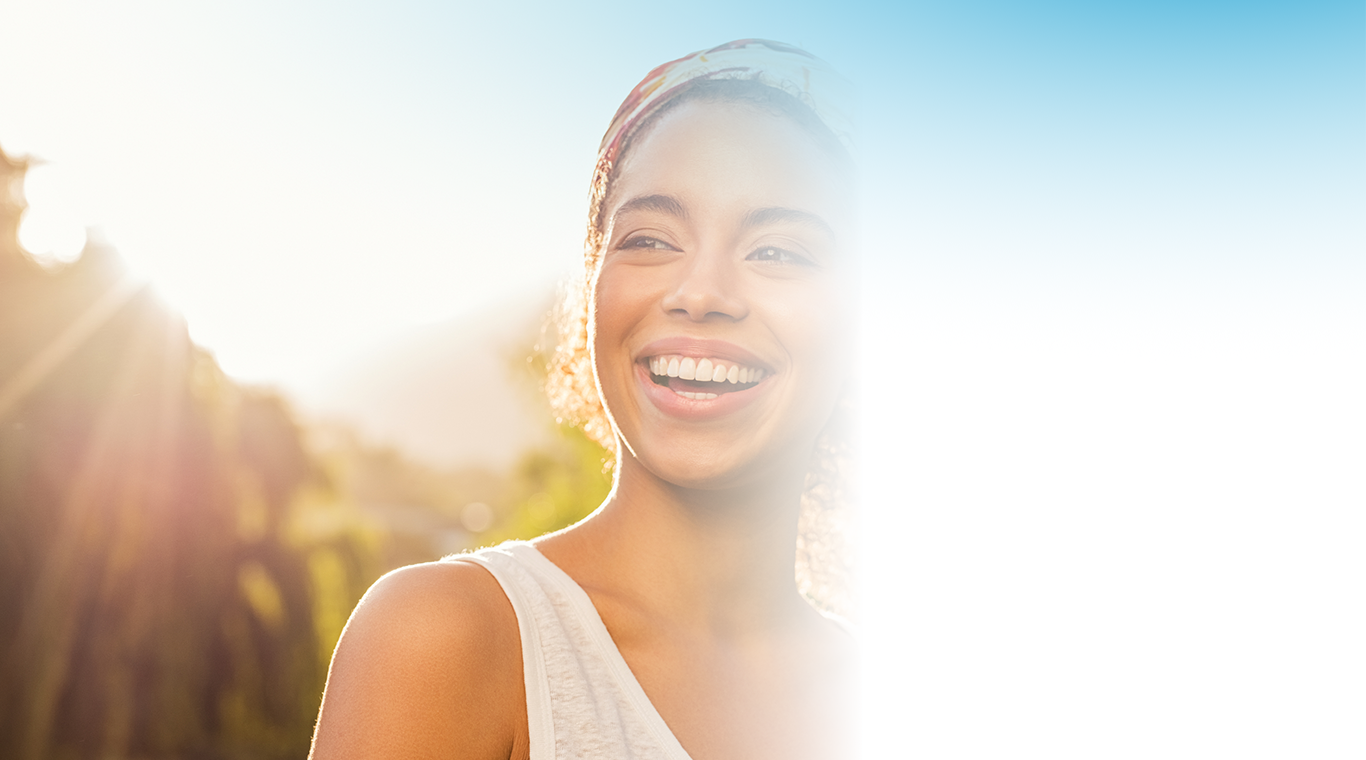 Welcome to The Next Breath Blog. Image shows a women smiling in the sun.